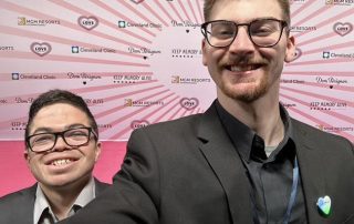 Caregivers Kyle Underwood (left) and Adam Haas (right) take a smiling photo together at a conference.