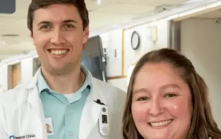 Two caregivers working together on a computer in a Med/Surg unit.