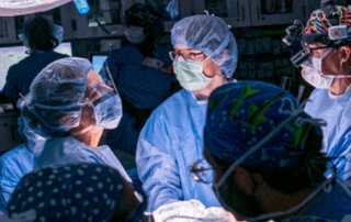 Team of surgeons performing an operation in a hospital operating room.