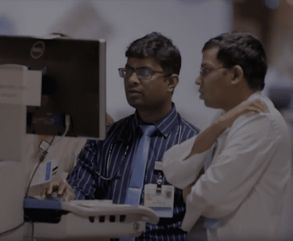 Two male professionals collaborating at a computer