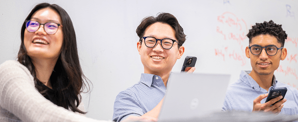 A group of smiling students within a classroom setting