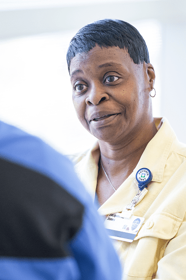 Close up of EVS Supervisor, Jackie Jones conferring with a fellow EVS team member.