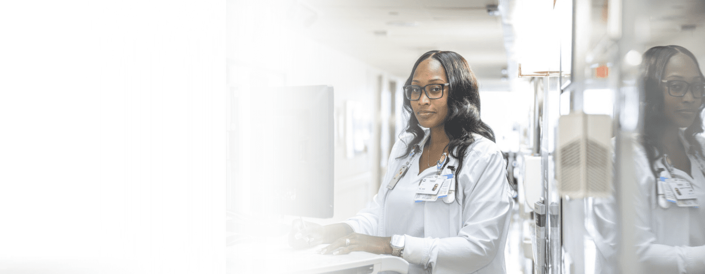Cleveland Clinic nurse working at a computer workstation in a hospital hallway